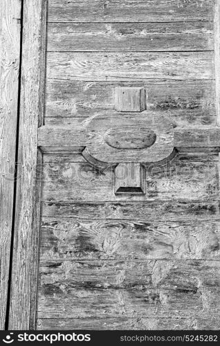 abstract texture of a brown antique wooden old door in italy europe