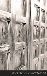 abstract texture of a brown antique wooden old door in italy europe