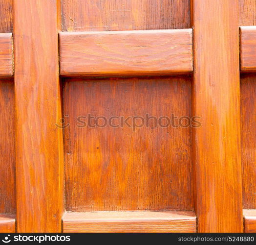 abstract texture of a brown antique wooden old door in italy europe