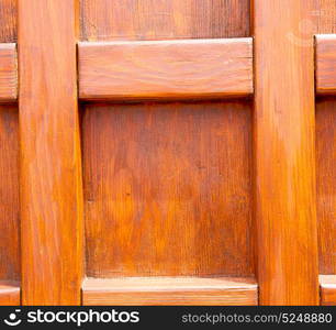 abstract texture of a brown antique wooden old door in italy europe