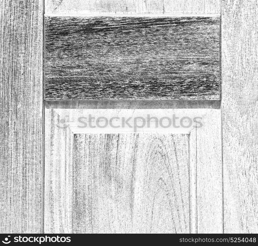 abstract texture of a brown antique wooden old door in italy europe