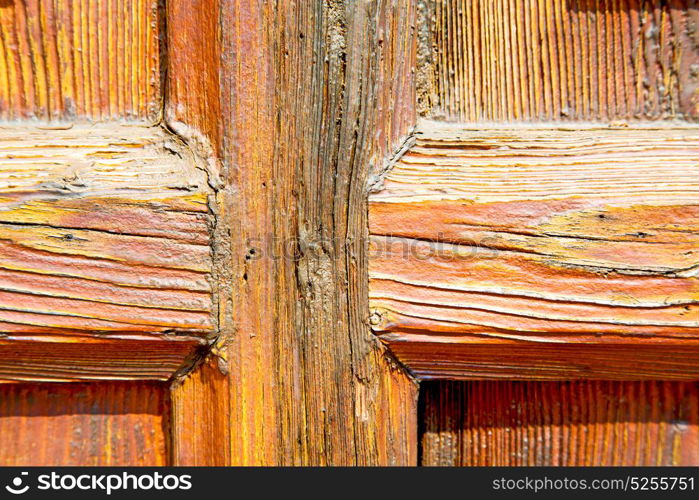 abstract texture of a brown antique wooden old door in italy europe