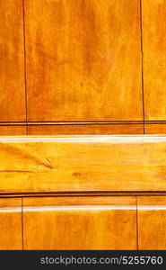 abstract texture of a brown antique wooden old door in italy europe