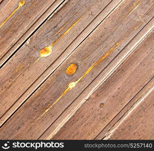 abstract texture of a brown antique wooden old door in italy europe