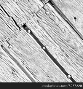 abstract texture of a brown antique wooden old door in italy europe