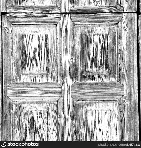 abstract texture of a brown antique wooden old door in italy europe