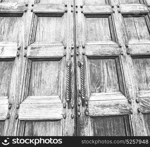 abstract texture of a brown antique wooden old door in italy europe