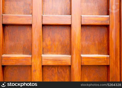 abstract texture of a brown antique wooden old door in italy europe