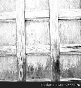 abstract texture of a brown antique wooden old door in italy europe