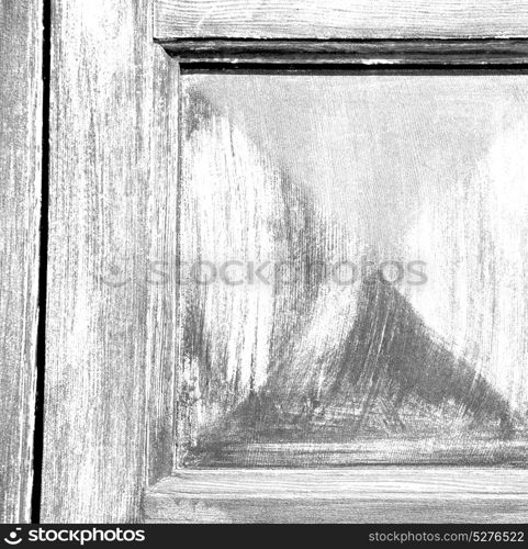 abstract texture of a brown antique wooden old door in italy europe