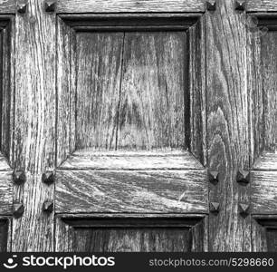 abstract texture of a brown antique wooden old door in italy europe