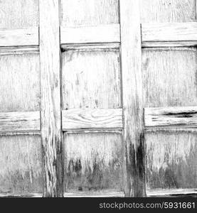 abstract texture of a brown antique wooden old door in italy europe