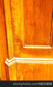 abstract texture of a brown antique wooden old door in italy europe