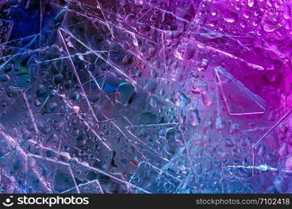 Abstract trendy holographic background in the style of the 80-90s. Real texture of broken glass and water drops in bright acid colors. Synthwave Vaporwave webpunk Massurrealism aesthetics.. Background in the style of the 80-90s. Real texture of broken glass and drops in bright acid colors.