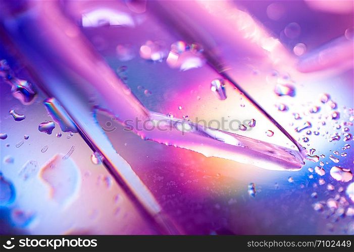 Abstract trendy holographic background in the style of the 80-90s. Real texture of broken glass or ice and water drops in bright acid colors. Synthwave Vaporwave webpunk Massurrealism aesthetics.. Background in the style of the 80-90s. Real texture of broken glass or ice and drops in bright acid colors.