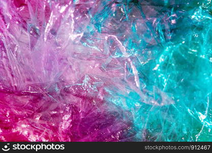 Abstract trendy holographic background in the style of the 80-90s. Real texture of crumpled cellophane film in bright acid colors. Synthwave Vaporwave webpunk Massurrealism aesthetics.. Holographic background in the style of the 80-90s. Real texture of cellophane film in bright acid colors.