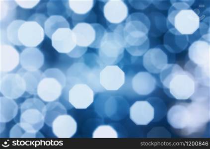 Abstract trendy pattern with bright bokeh and lens flare effect . Color of the year 2020 - Classic Blue. Creative modern blurred background with space for copy and design.