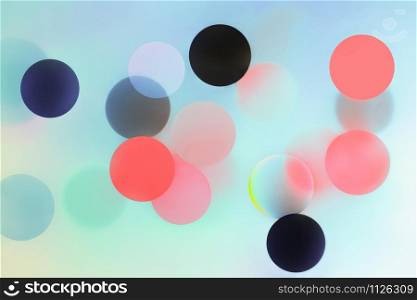 Abstract trendy pattern with bright colorful balls and bokeh. Creative modern blurred background with digital gradient effects. Space for copy and design.