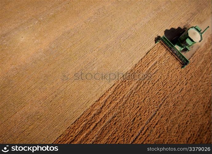 Abstract view of a combine harvesting lentils in a large field