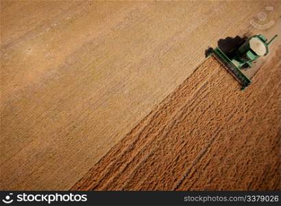 Abstract view of a combine harvesting lentils in a large field