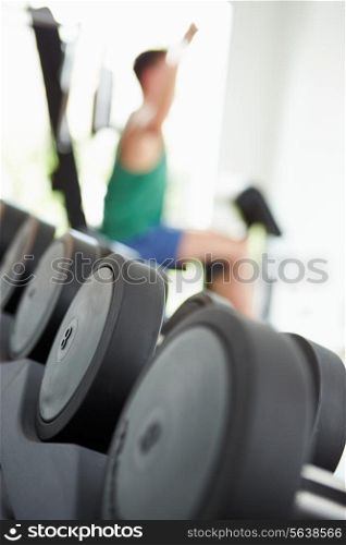 Abstract View Of Man Training With Weights In Gym
