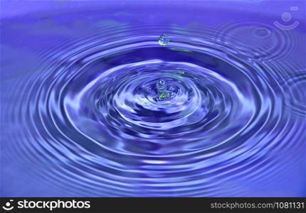 Abstract wave water drop on purple background.