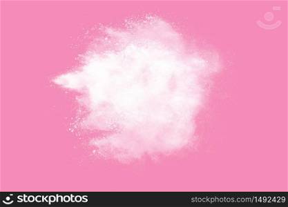 Abstract white powder explosion. Closeup of white dust particle splash isolated on pink background.