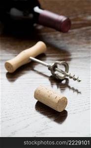 Abstract Wine Bottle, Cork and Corkscrew Laying on a Reflective Wood Surface.