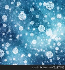Abstract winter backgrounds with snow flakes over frozen blue texture