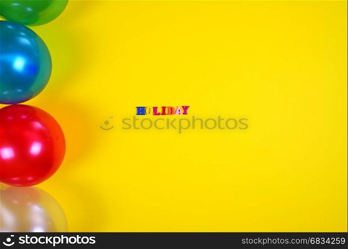 Abstract yellow background with balloons and inscription holiday, blank space on the right