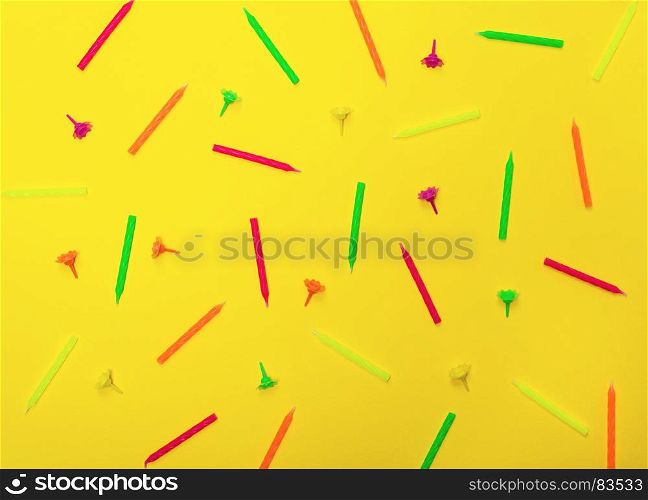 abstract yellow background with wax candles for celebratory cake, close up