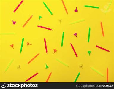 abstract yellow background with wax candles for celebratory cake, close up