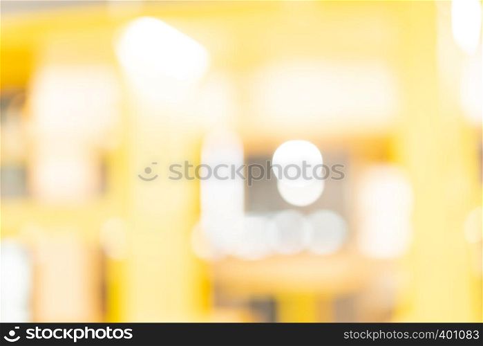 abstract yellow blur background at shopping mall for design , Bokeh on yellow background