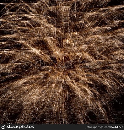Abstract yellow fireworks on the black sky background. Holiday celebration.