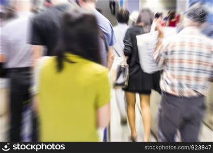 Abstract zooming passengers in subway station