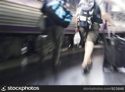 Abstract zooming travelers walking in the train station
