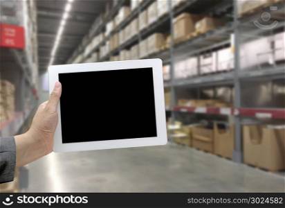 Abstrast Blurred background : Warehouse cargo with digital tablet