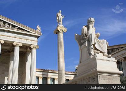 Academy of Athens in Greece. Image shows part of the main building of the neoclassical National Academy of Athens, statue of god Apollo on top of an ionic column and ancient Greek philosopher Socrates.