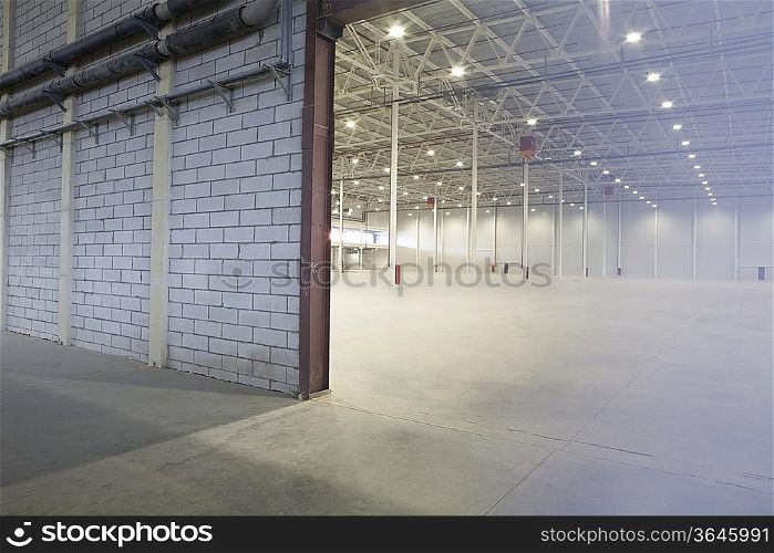 Access door to brightly lit and empty warehouse
