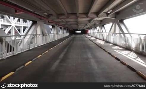 Access to parking garage. Underground parking interior in modern industrial building, public construction. Empty driveway. Slow motion