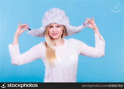 Accessories and clothes for cold days, fashion concept. Blonde woman in winter warm furry hat in russian style.. Blonde woman in winter warm furry hat