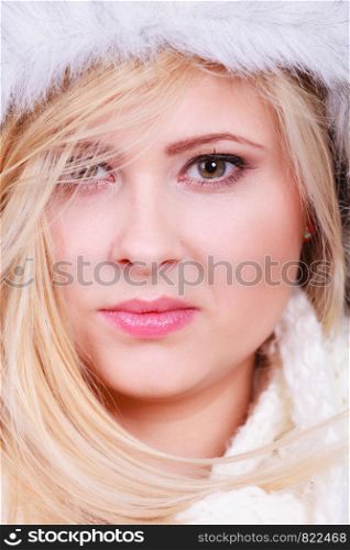 Accessories and clothes for cold days, fashion concept. Blonde woman in winter warm furry hat in russian style. Blonde woman in winter furry hat