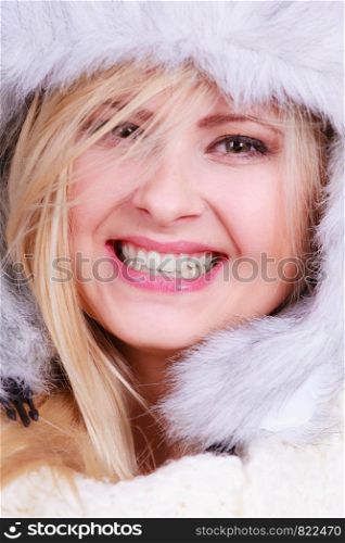 Accessories and clothes for cold days, fashion concept. Happy blonde woman in winter warm furry hat in russian style. Blonde woman in winter furry hat