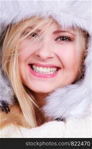 Accessories and clothes for cold days, fashion concept. Happy blonde woman in winter warm furry hat in russian style. Blonde woman in winter furry hat