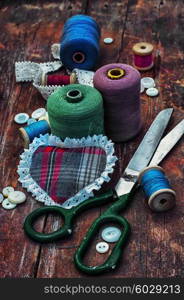 Accessories for home crafts. button and spools of thread for needlework on bright background