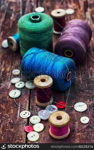 Accessories for home crafts. button and spools of thread for needlework on bright background