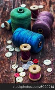 Accessories for home crafts. button and spools of thread for needlework on bright background