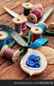 Accessories for home crafts. button and spools of thread for needlework on bright background