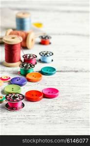 Accessories for repair and sewing of clothes and jewelry.Selective focus. Buttons and thread.