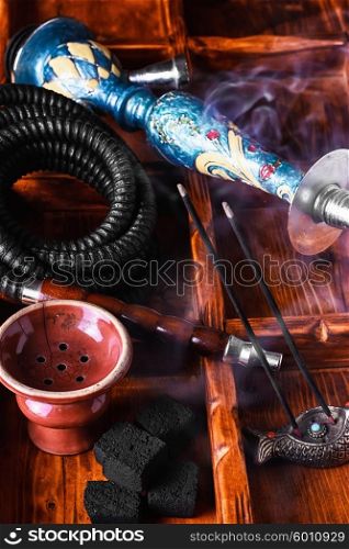 Accessories for Shisha. Dismantled parts of hookah on wooden background